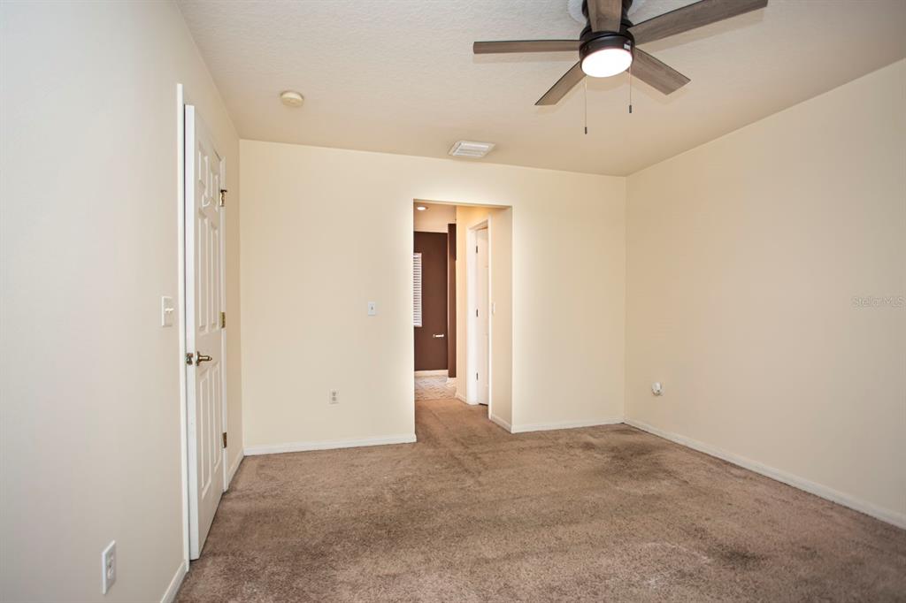 6740 Moonglow Drive, Unit 101 Port Richey, FL 34668 - Photo 27 of 39 an empty room with closet and a chandelier fan