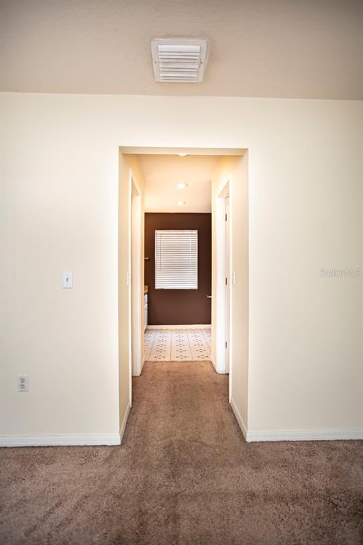 6740 Moonglow Drive, Unit 101 Port Richey, FL 34668 - Photo 28 of 39 a view of a hallway with wooden floor