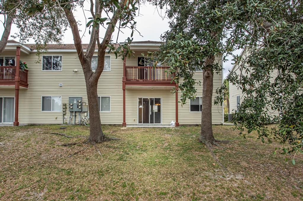 6740 Moonglow Drive, Unit 101 Port Richey, FL 34668 - Photo 32 of 39 a front view of a house with a garden