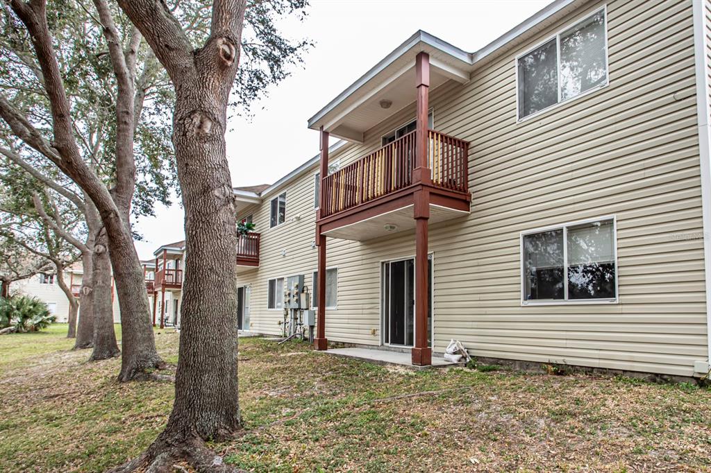 6740 Moonglow Drive, Unit 101 Port Richey, FL 34668 - Photo 33 of 39 a view of a house with a yard