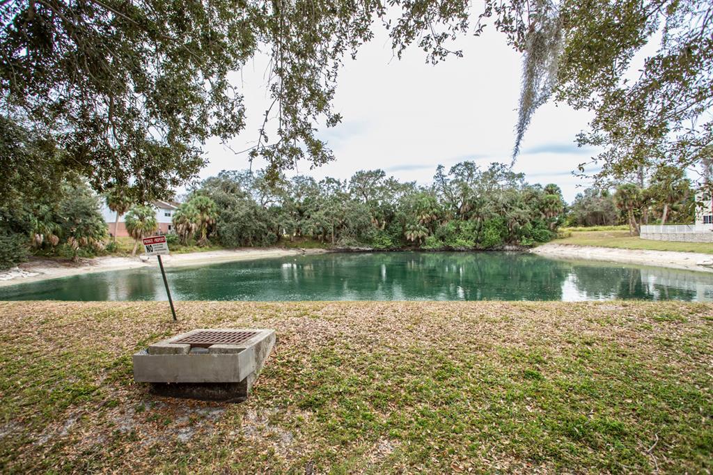 6740 Moonglow Drive, Unit 101 Port Richey, FL 34668 - Photo 38 of 39 a lake view with a lake view