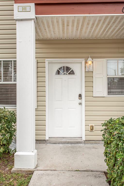 6740 Moonglow Drive, Unit 101 Port Richey, FL 34668 - Photo 5 of 39 a view of a house with a door and a window