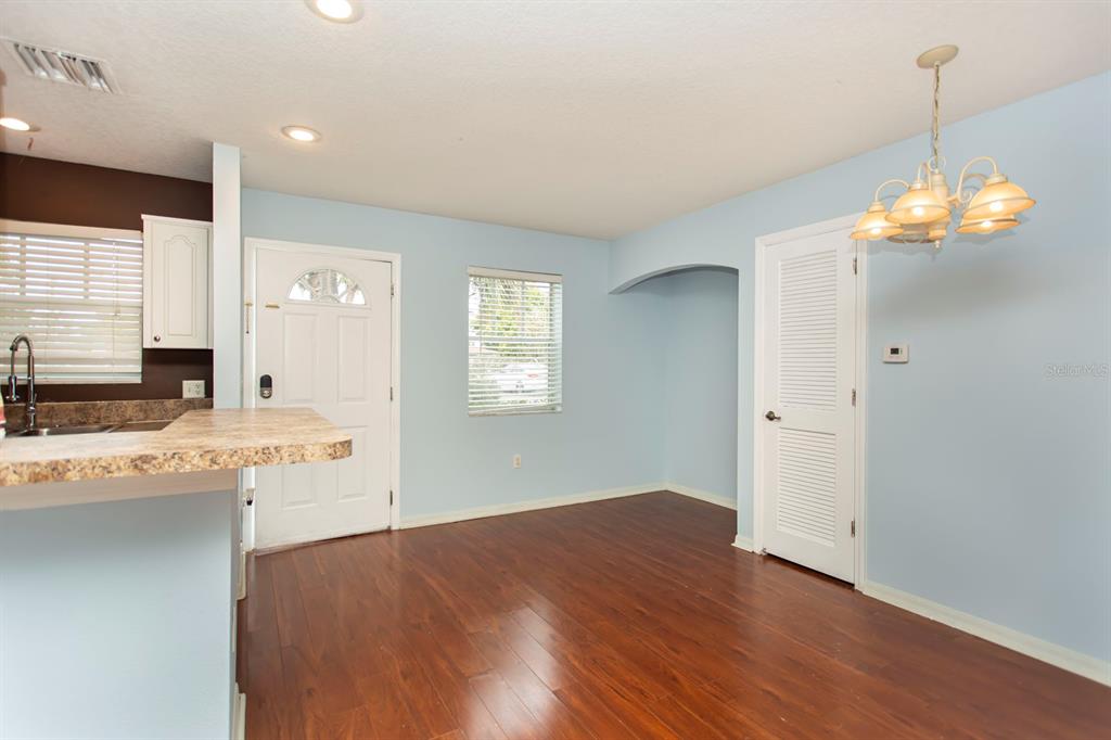 6740 Moonglow Drive, Unit 101 Port Richey, FL 34668 - Photo 10 of 39 a view of a kitchen with a sink dishwasher and wooden floor