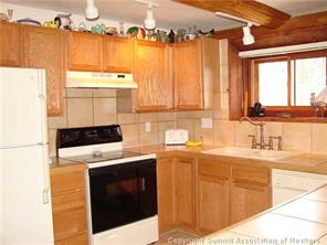 199 Sheep Ridge Road Fairplay, CO 80440 - Photo 2 of 16 a kitchen with a stove a sink and a refrigerator