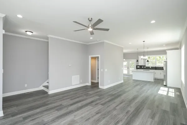 a view of a kitchen with wooden floor and a kitchen