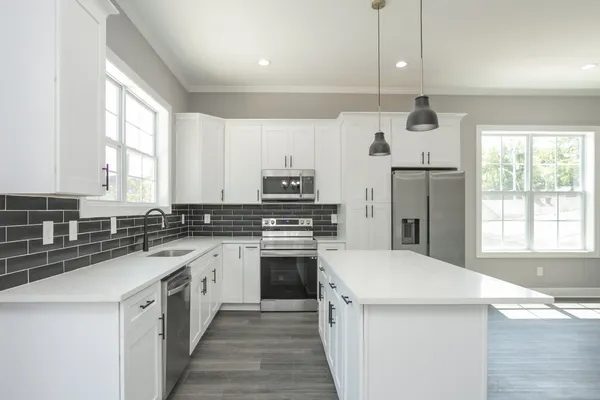 a kitchen with a sink stove and refrigerator