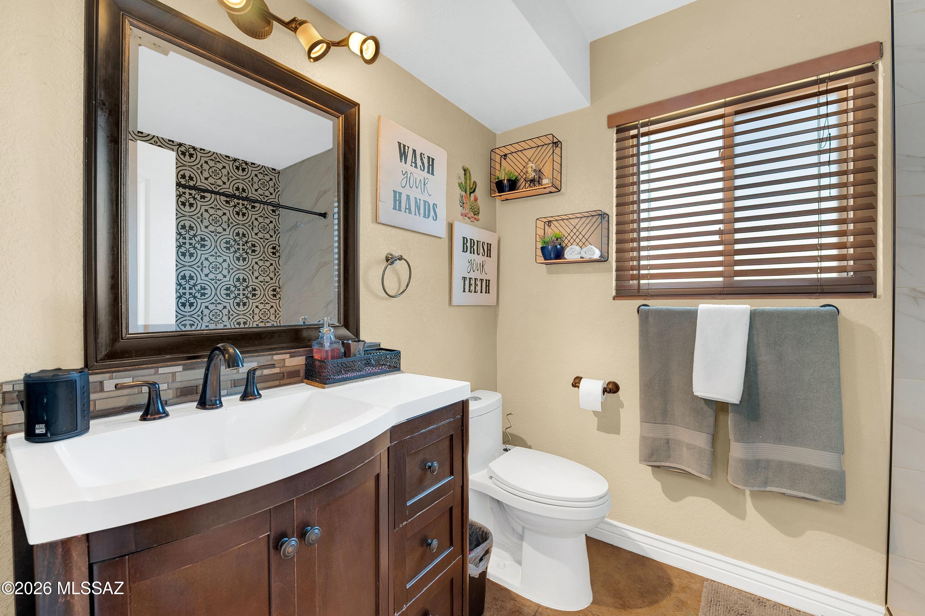 7159 West Maple Ridge Drive Tucson, AZ 85743 - Photo 24 of 42 a bathroom with a sink a toilet and shower