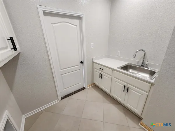 a kitchen with a sink and washing machine