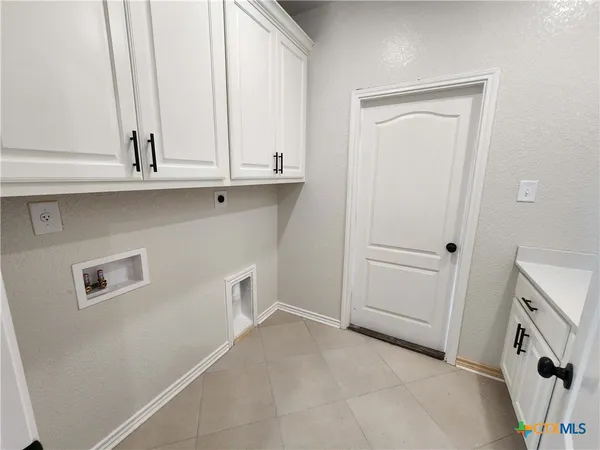 a view of a kitchen with cabinets and a ceiling fan