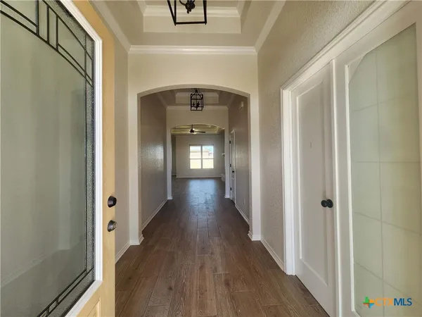 a view of a hallway with wooden floor