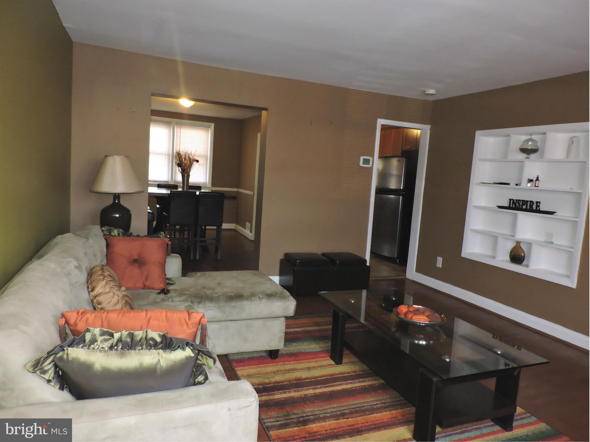 1218 Kevin Road Baltimore, MD 21229 - Photo 5 of 27 a living room with furniture and a mirror