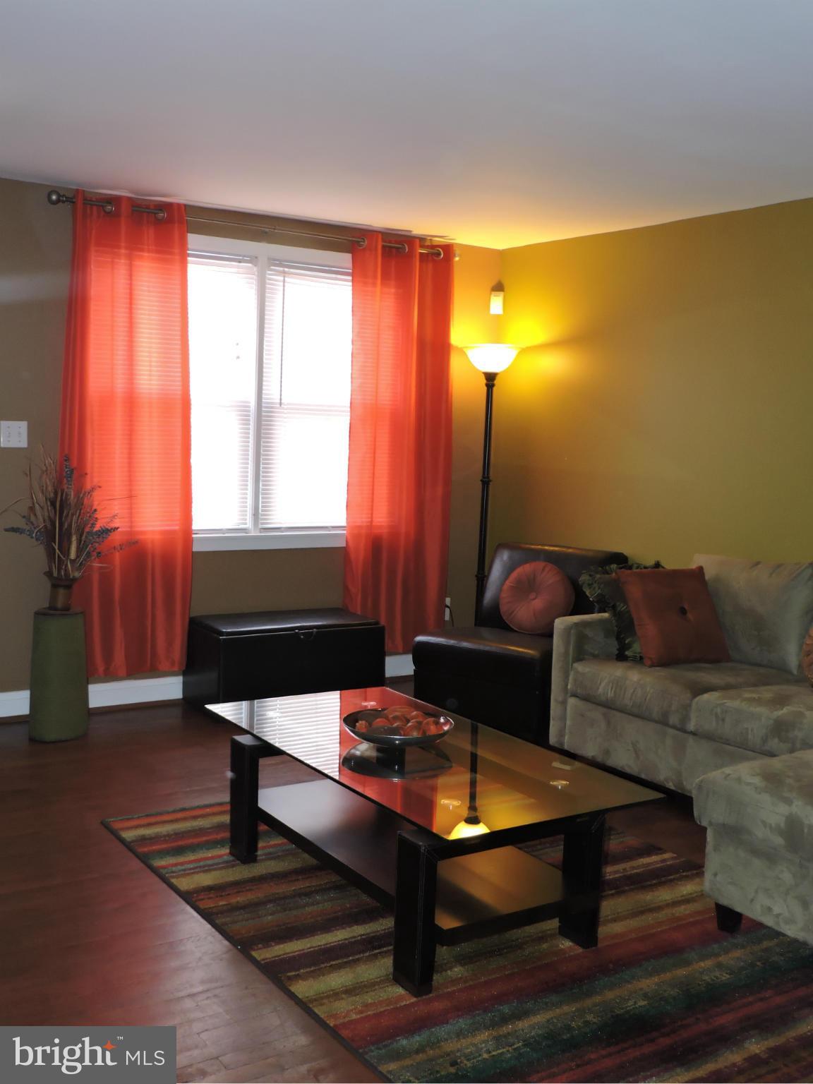 1218 Kevin Road Baltimore, MD 21229 - Photo 7 of 27 a living room with furniture and a lamp