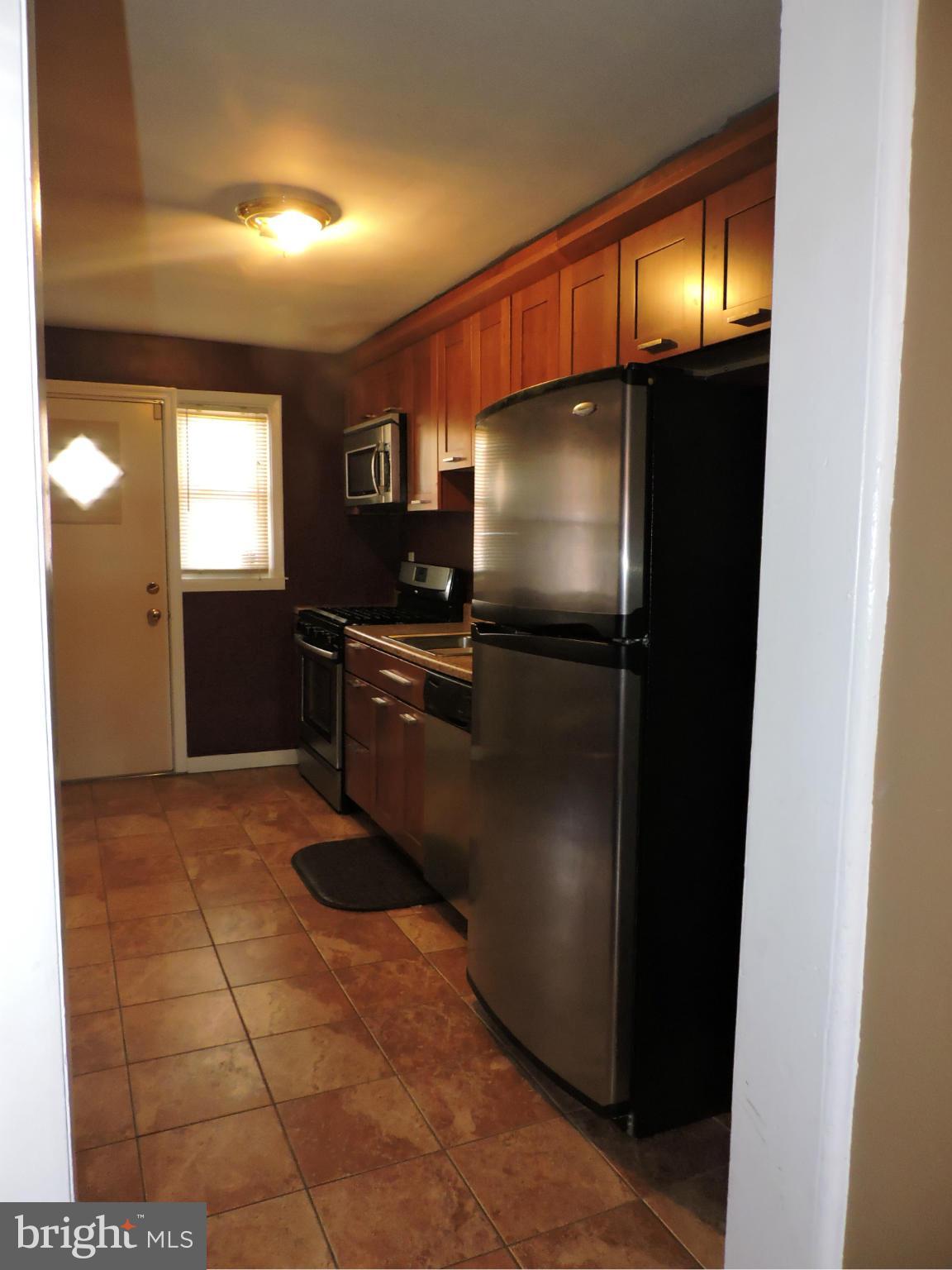 1218 Kevin Road Baltimore, MD 21229 - Photo 9 of 27 a kitchen with granite countertop a refrigerator and a sink