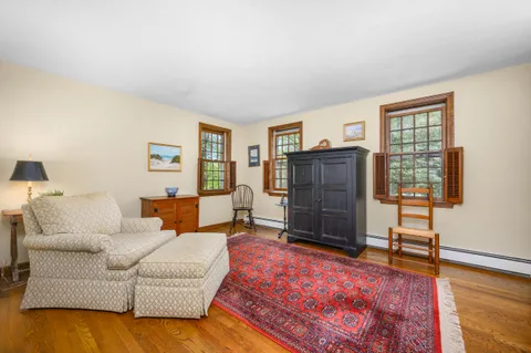 a living room with furniture and a dresser