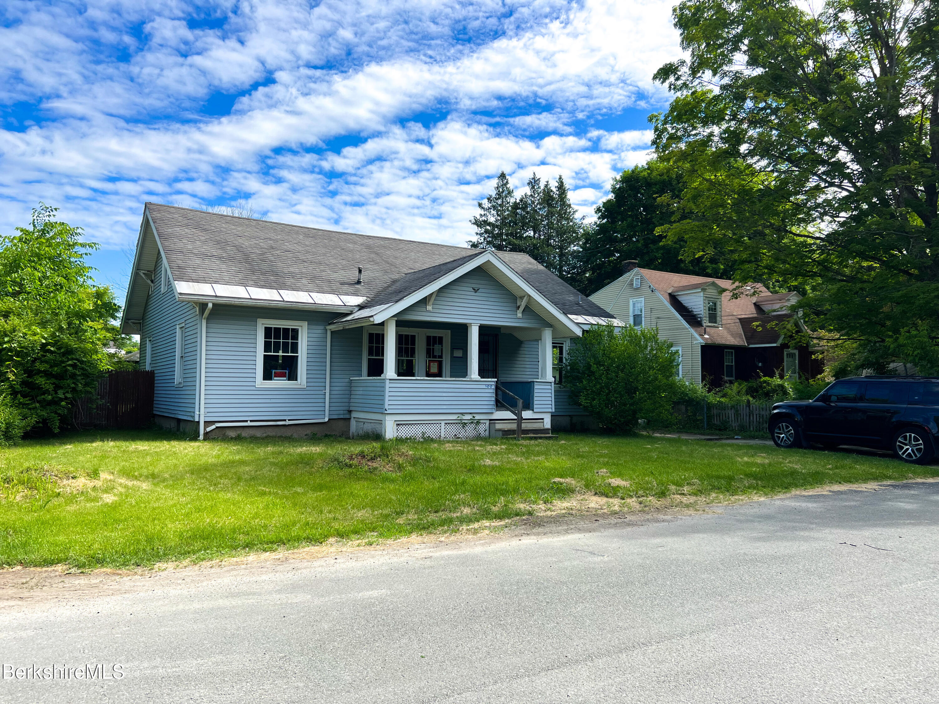 100 Boylston Street Pittsfield, MA 01201 - Photo 4 of 32 a front view of a house with a garden and trees