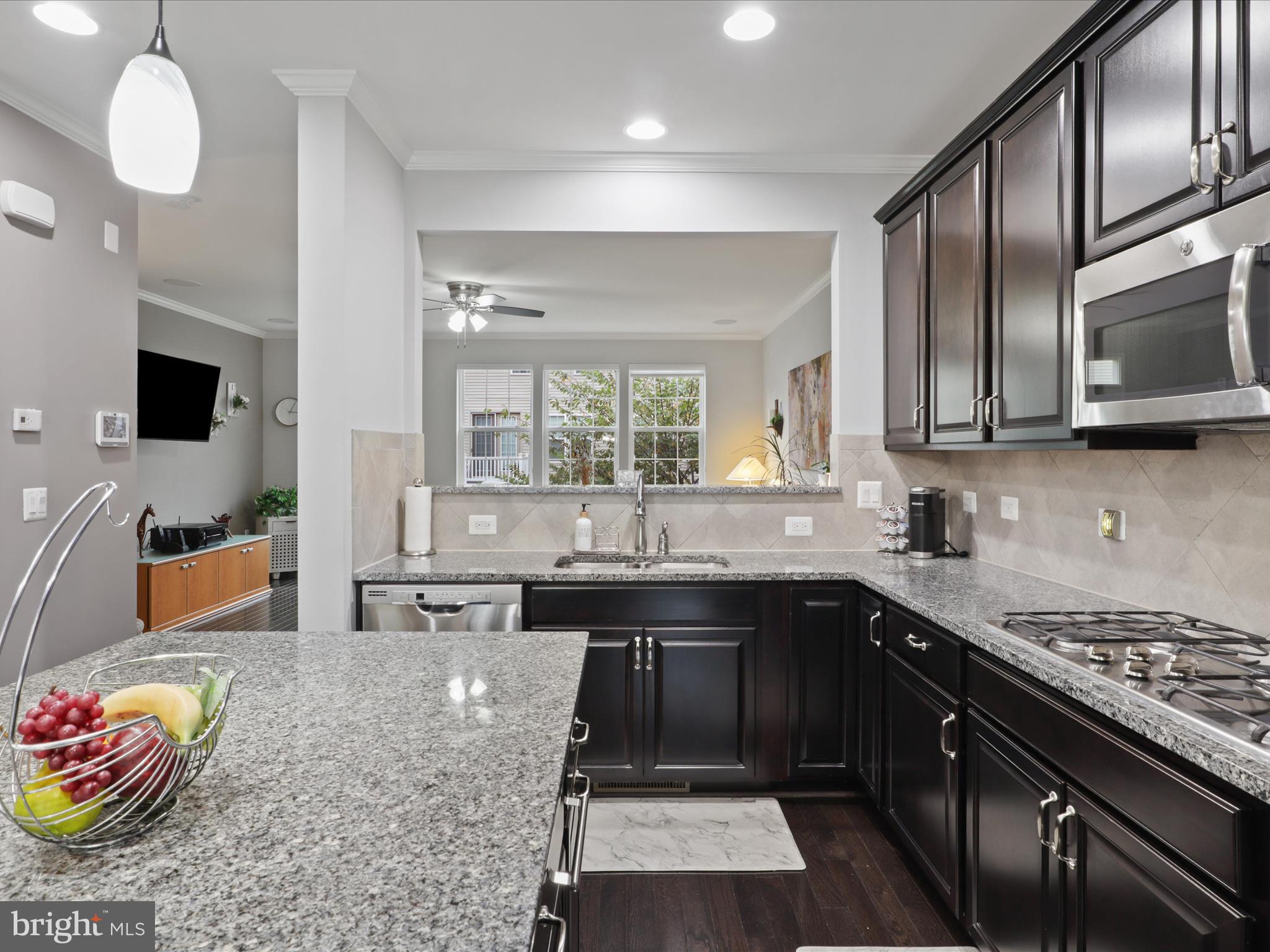 16006 Madison Ridge Place Gainesville, VA 20155 - Photo 15 of 48 a kitchen with stainless steel appliances granite countertop a stove sink and cabinets