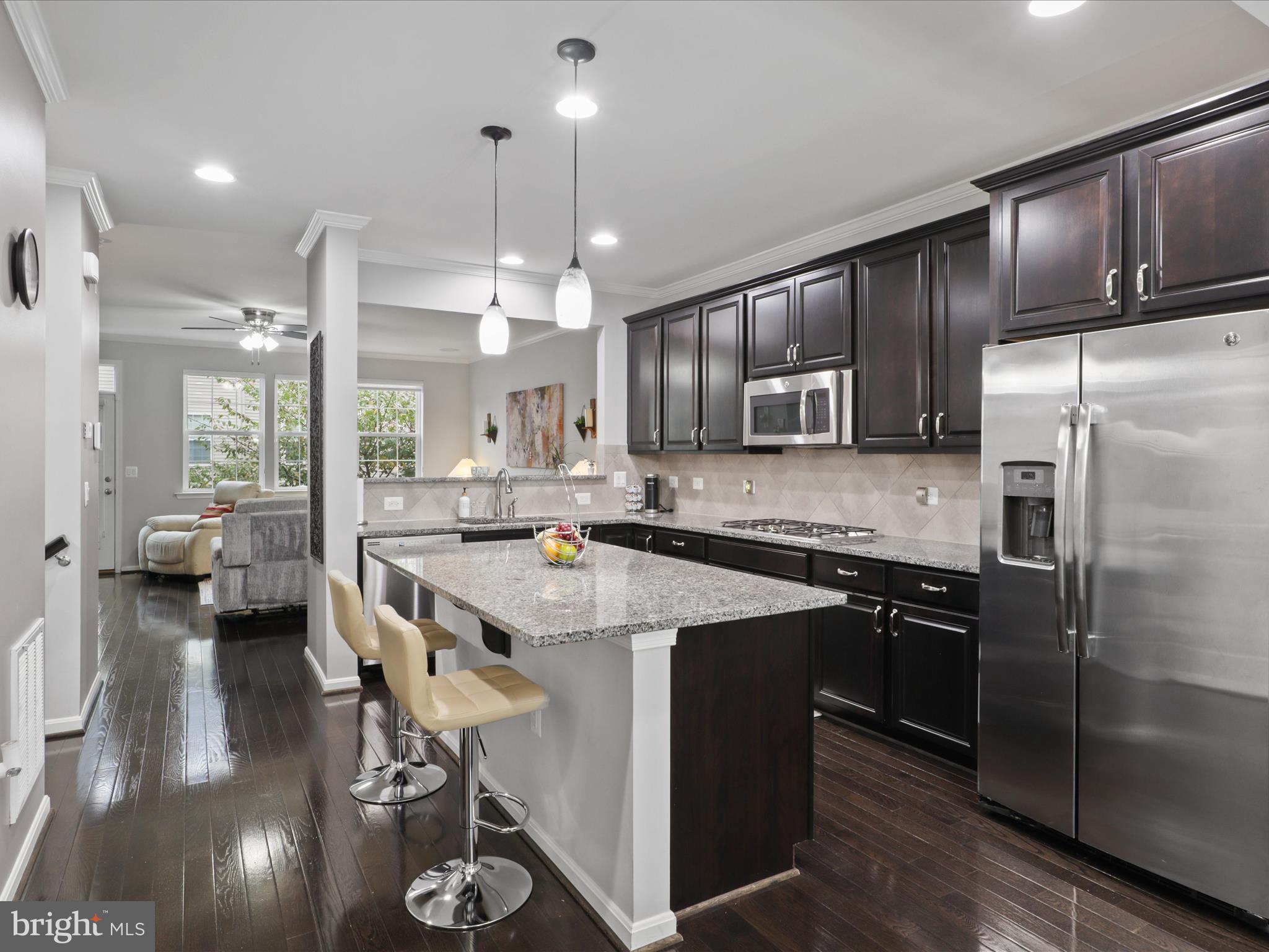 16006 Madison Ridge Place Gainesville, VA 20155 - Photo 17 of 48 a kitchen with stainless steel appliances granite countertop a sink stove and refrigerator