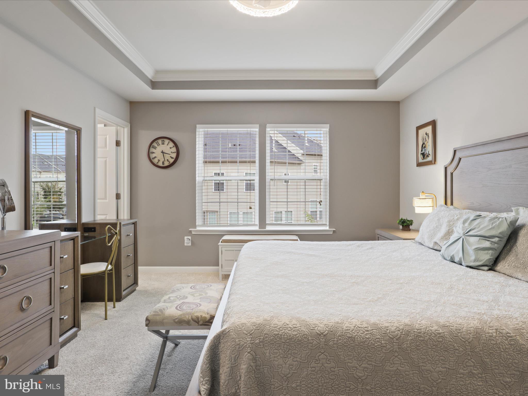 16006 Madison Ridge Place Gainesville, VA 20155 - Photo 25 of 48 a bedroom with a bed a dresser next to a window