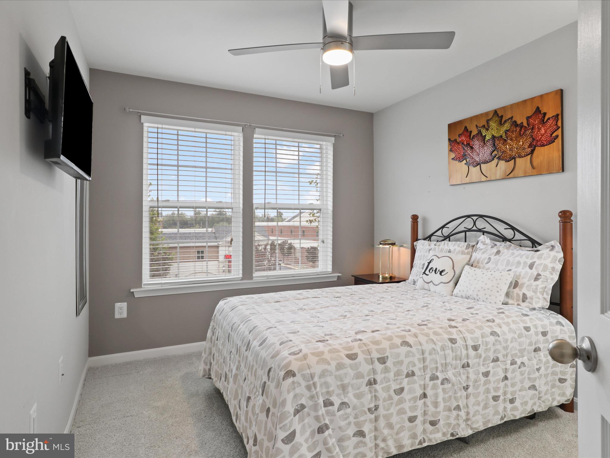 16006 Madison Ridge Place Gainesville, VA 20155 - Photo 29 of 48 a bedroom with a large bed and a flat tv screen on dresser