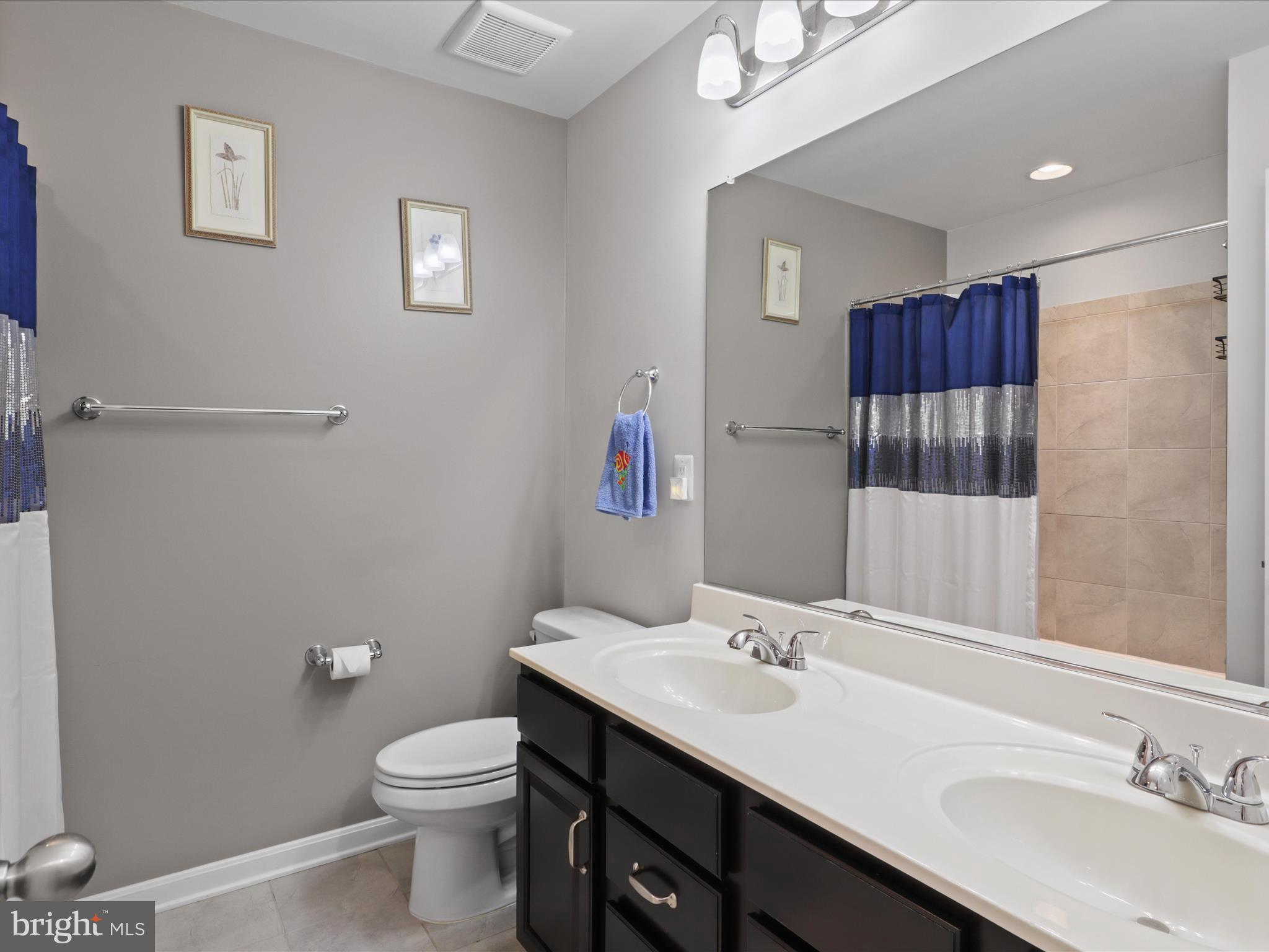 16006 Madison Ridge Place Gainesville, VA 20155 - Photo 31 of 48 a bathroom with a sink and a mirror