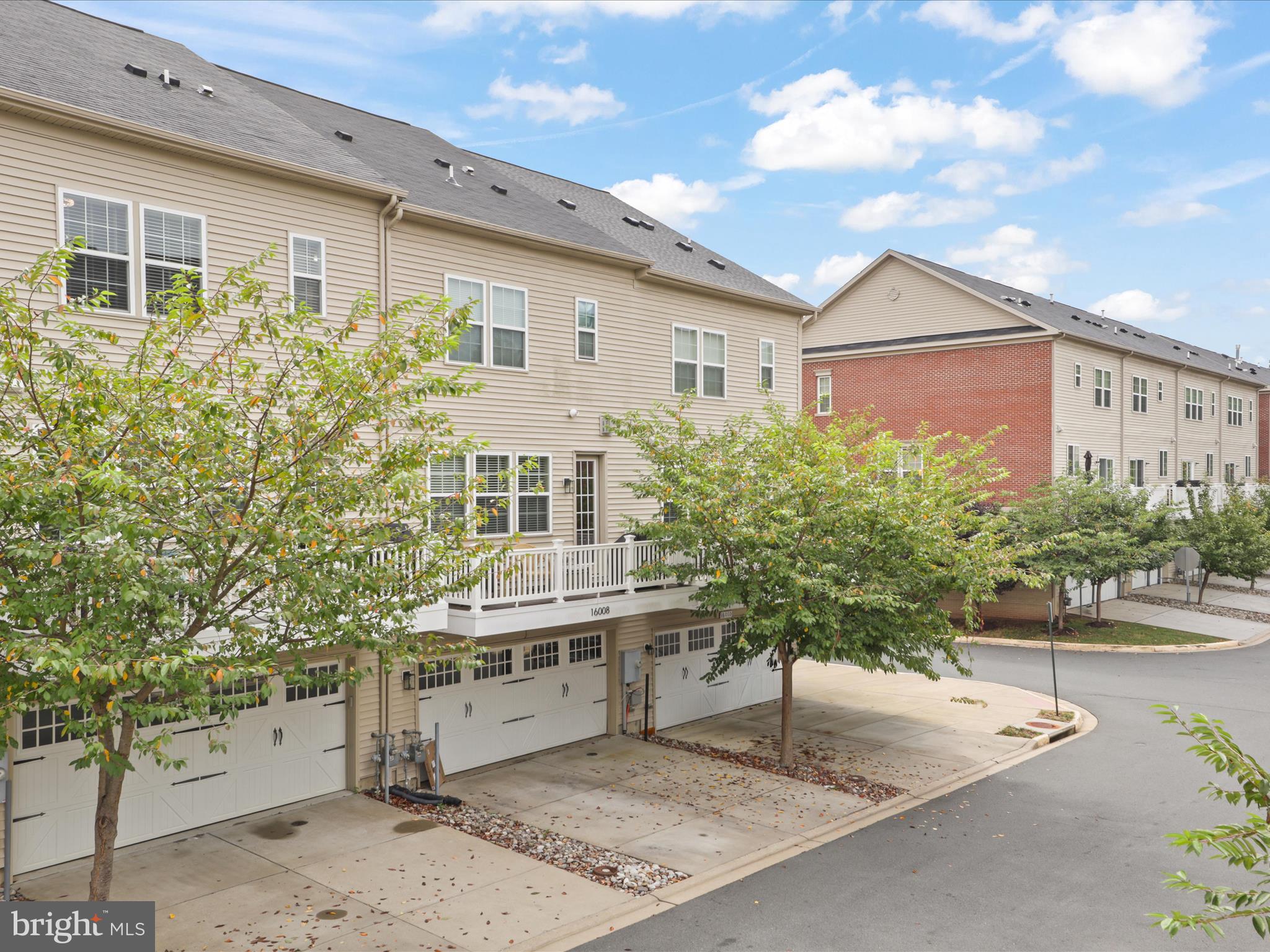 16006 Madison Ridge Place Gainesville, VA 20155 - Photo 35 of 48 a view of a house with a yard and potted plants