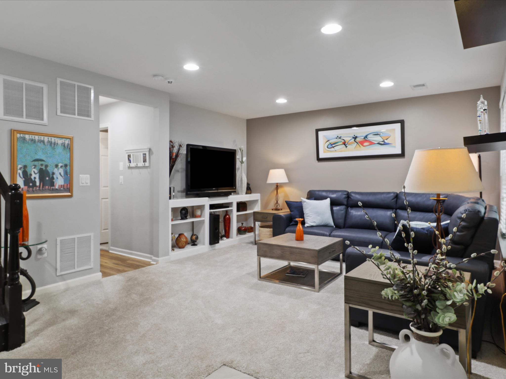 16006 Madison Ridge Place Gainesville, VA 20155 - Photo 8 of 48 a living room with furniture and a flat screen tv