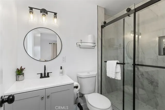 a bathroom with a toilet a sink and a mirror