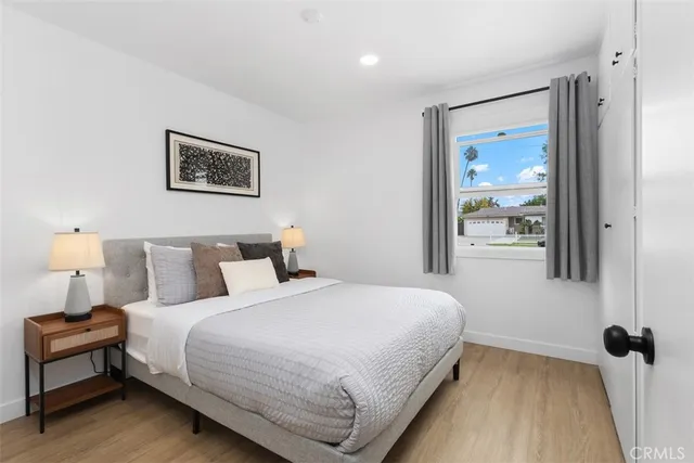 a bedroom with a bed and a painting on the wall