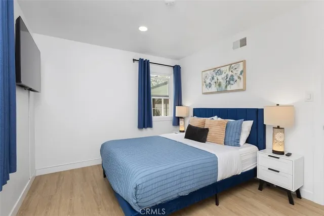 a bedroom with a bed and a night stand