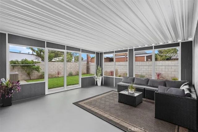 a living room with furniture and a garden