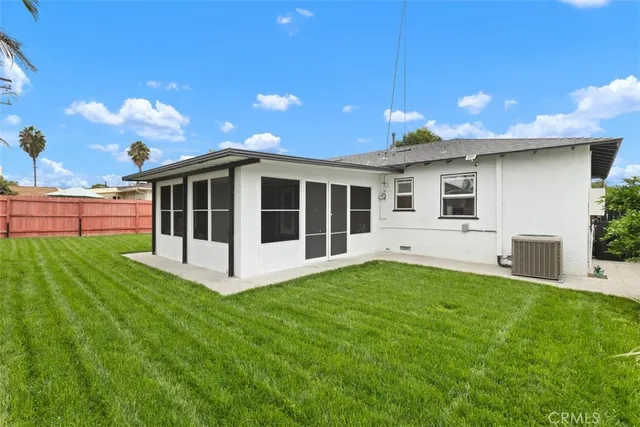 a view of a house with a yard and sitting area