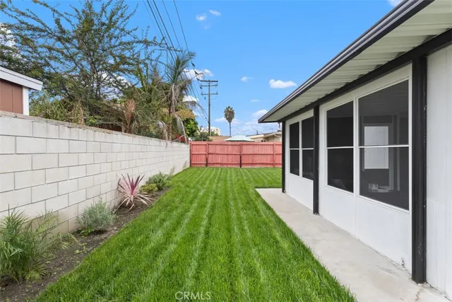 a view of house with backyard