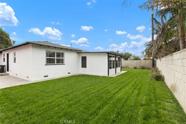 a view of a backyard with plants and a backyard