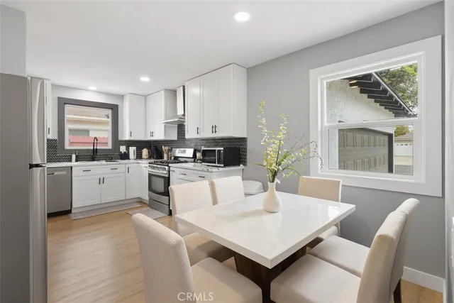 a kitchen with white cabinets and white appliances