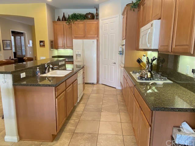 80278 Camino San Mateo Indio, CA 92203 - Photo 11 of 63 a kitchen with stainless steel appliances granite countertop a sink stove and refrigerator