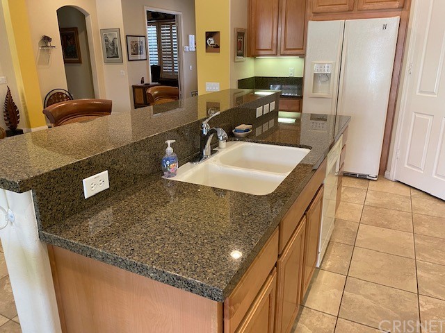 80278 Camino San Mateo Indio, CA 92203 - Photo 14 of 63 a kitchen with stainless steel appliances granite countertop a sink a stove and a refrigerator