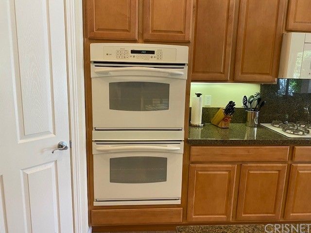 a white refrigerator freezer sitting inside of a kitchen