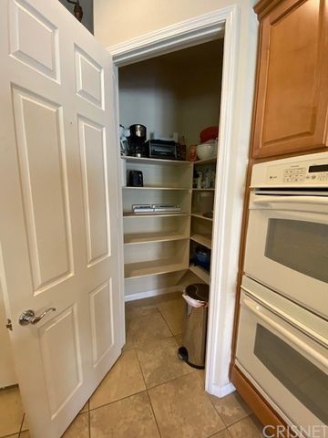 a kitchen with granite countertop cabinets and refrigerator