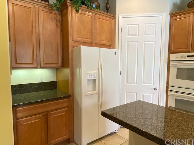 80278 Camino San Mateo Indio, CA 92203 - Photo 19 of 63 a kitchen with granite countertop cabinets and refrigerator