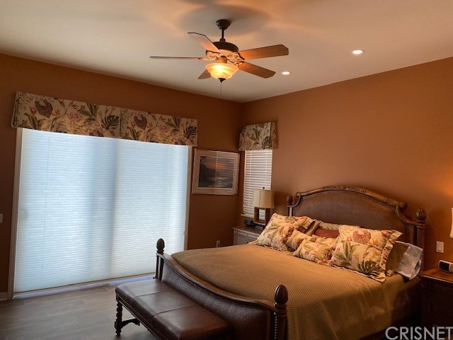 80278 Camino San Mateo Indio, CA 92203 - Photo 22 of 63 a bedroom with a bed and a chandelier
