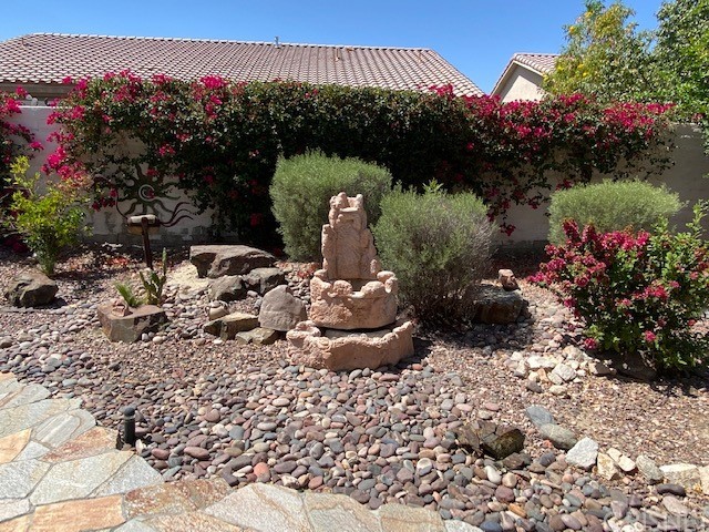 80278 Camino San Mateo Indio, CA 92203 - Photo 54 of 63 a view of a garden with a lot of flower plants and wooden fence