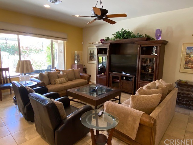80278 Camino San Mateo Indio, CA 92203 - Photo 6 of 63 a living room with furniture a flat screen tv and a large window