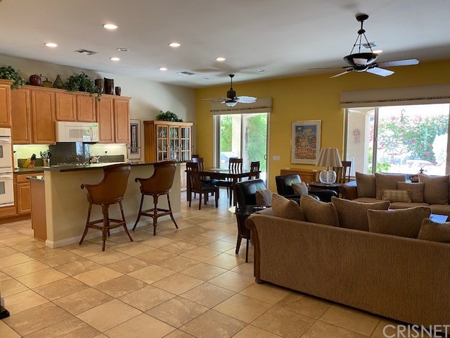 80278 Camino San Mateo Indio, CA 92203 - Photo 8 of 63 a living room with furniture a dining table and chairs