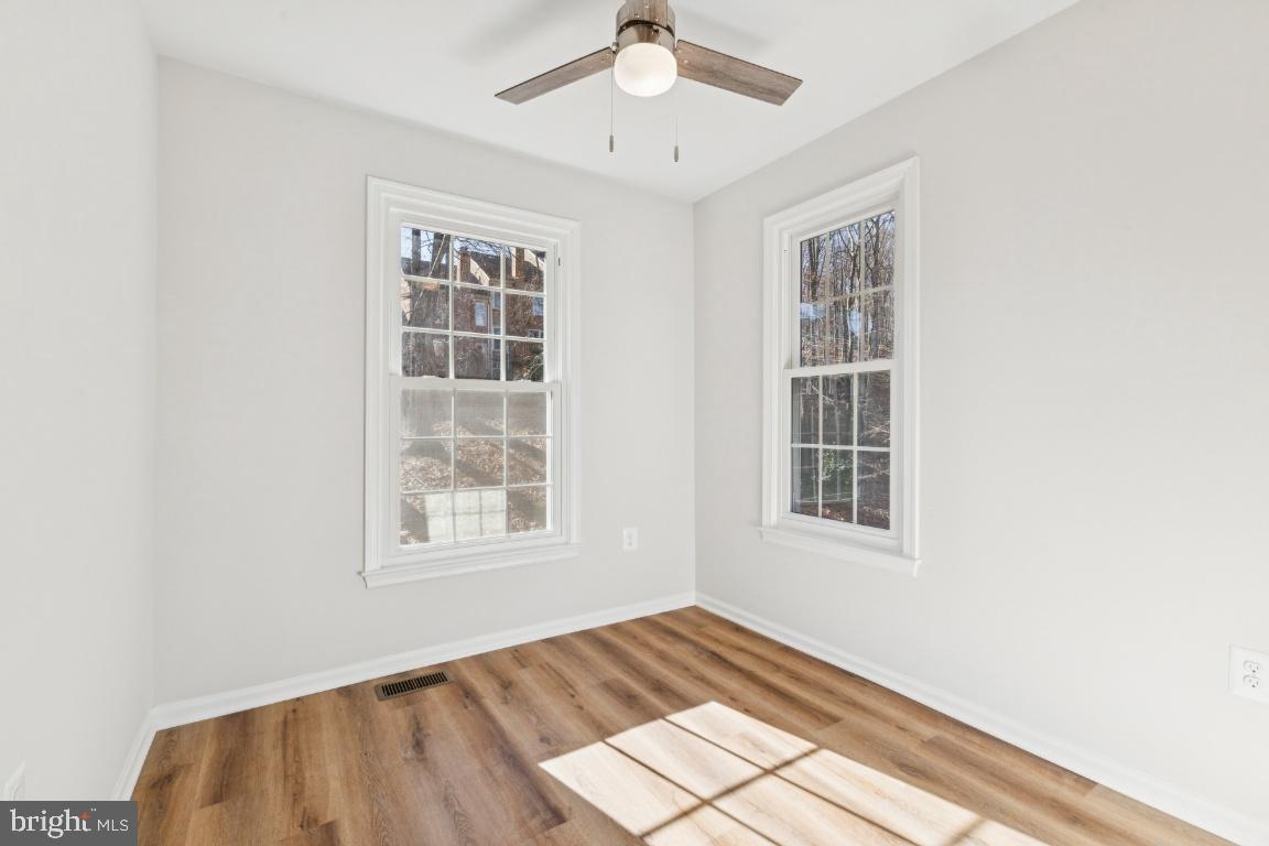 2452 South Walter Reed Drive, Unit 3 Arlington, VA 22206 - Photo 15 of 32 a view of an empty room with wooden floor and a window