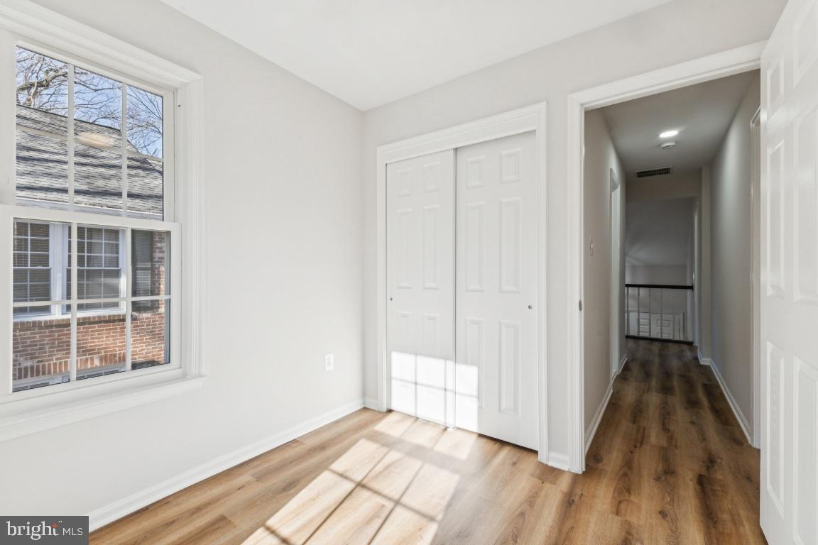 2452 South Walter Reed Drive, Unit 3 Arlington, VA 22206 - Photo 16 of 32 a view of wooden floor and windows in a room