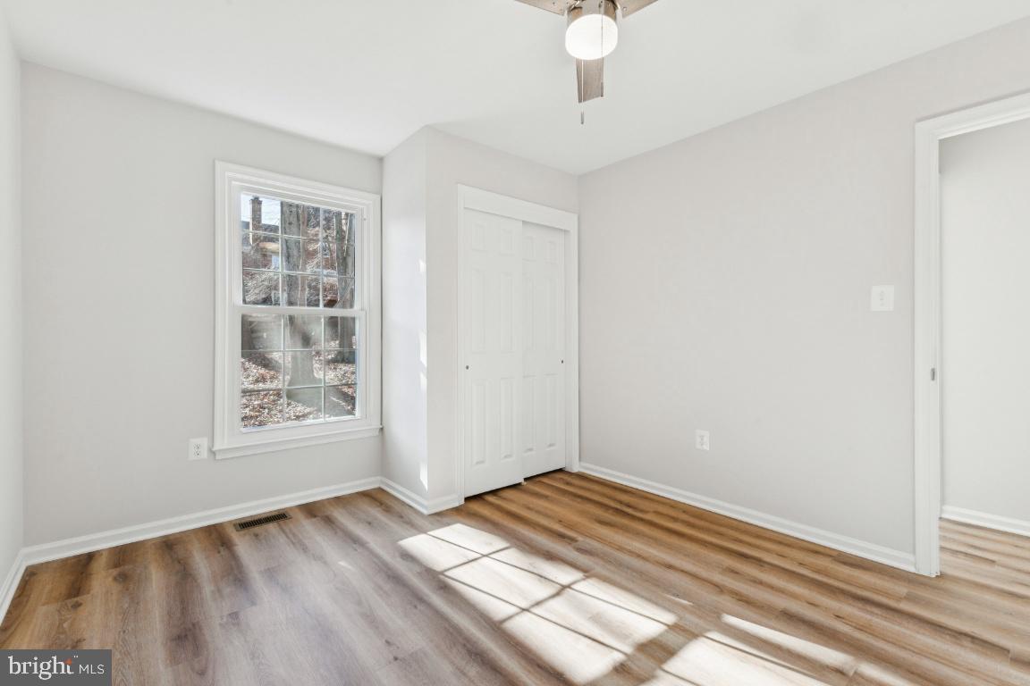 2452 South Walter Reed Drive, Unit 3 Arlington, VA 22206 - Photo 19 of 32 wooden floor in an empty room with a window