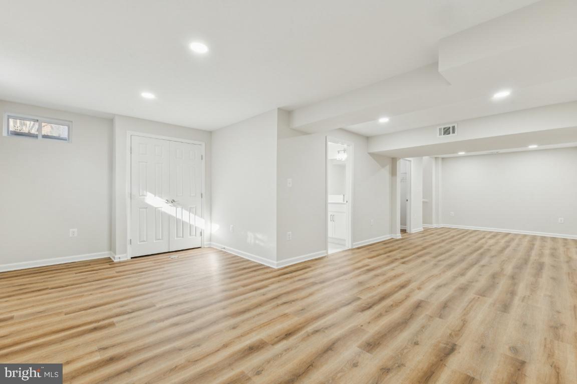 2452 South Walter Reed Drive, Unit 3 Arlington, VA 22206 - Photo 21 of 32 a view of an empty room with wooden floor