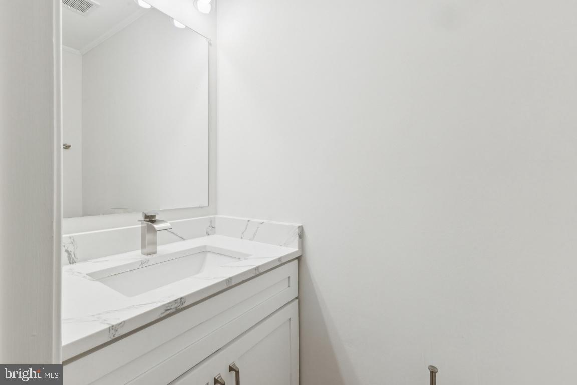 2452 South Walter Reed Drive, Unit 3 Arlington, VA 22206 - Photo 9 of 32 a bathroom with a sink and a mirror