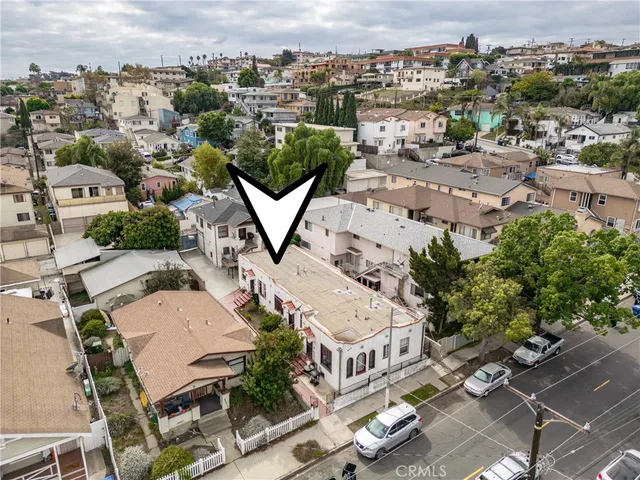 an aerial view of a residential houses with city view