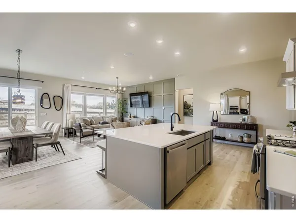 a open kitchen with white cabinets and stainless steel appliances